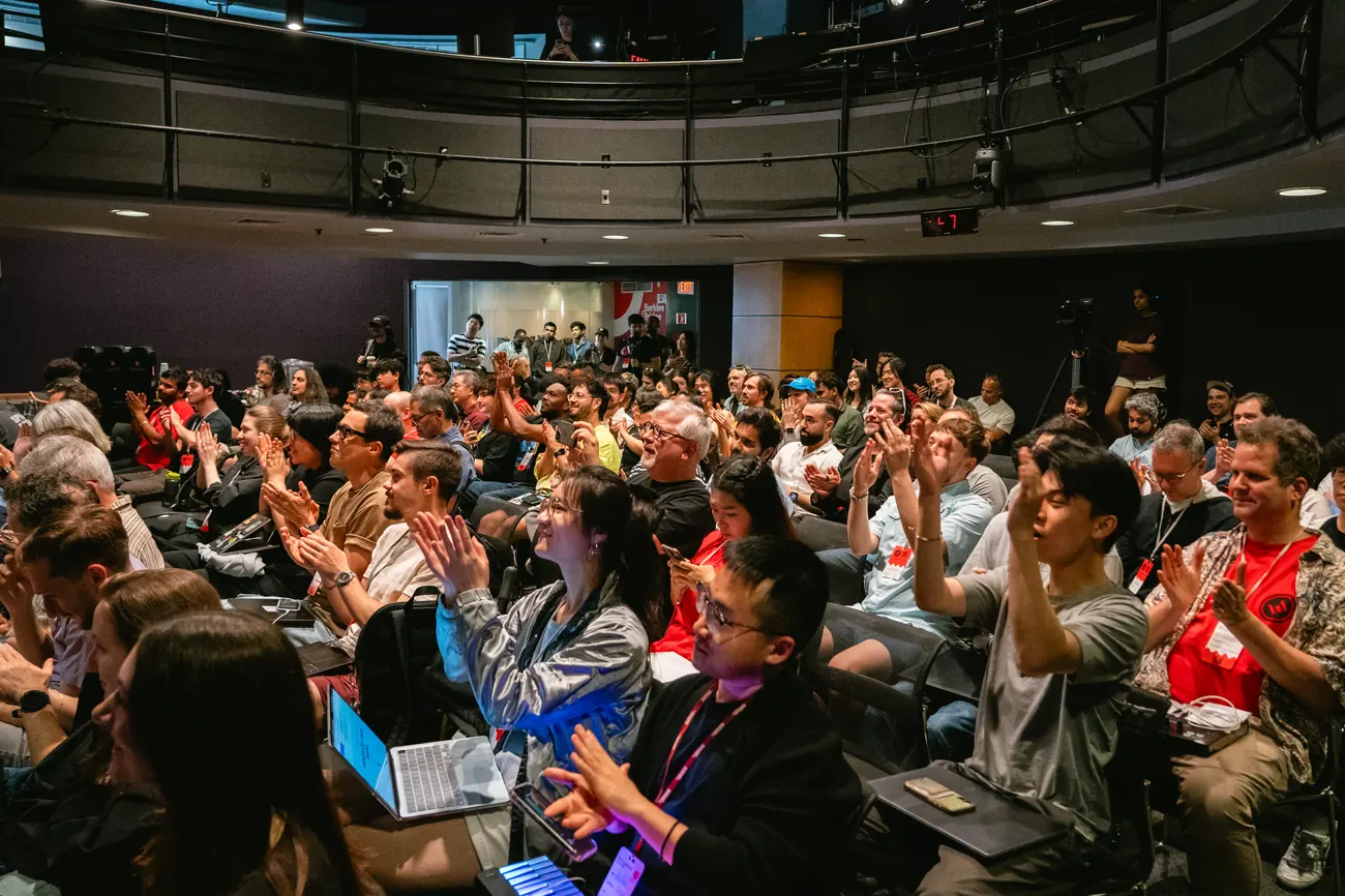 Audience applauding the AURALINK presentation