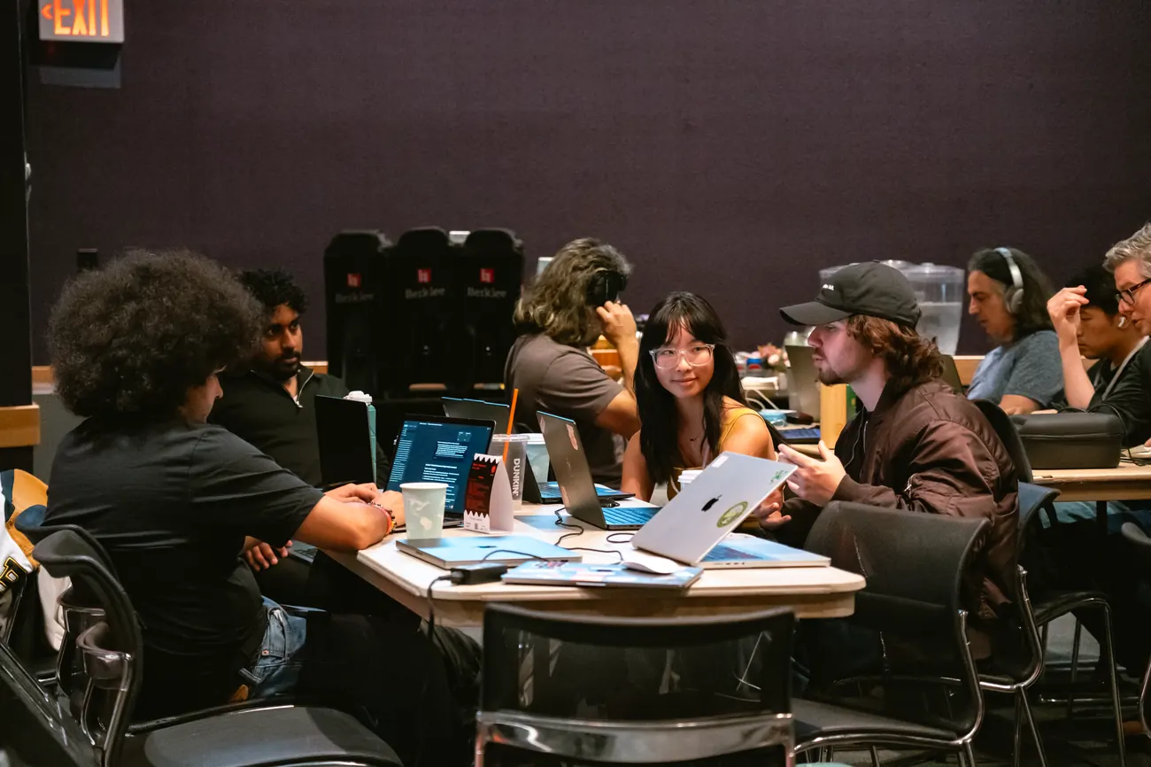 Team members collaborating on laptops during the hackathon